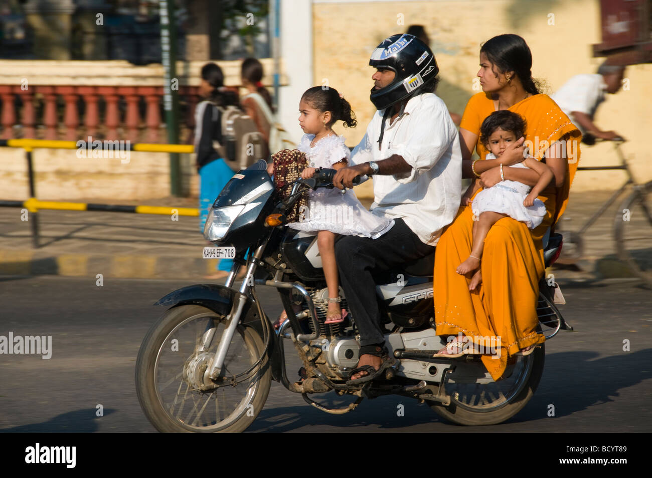 An Indian family on a motorbike in India Ratan Tata has said seeing whole famiies on one bike was his inspiration for the Nano Stock Photo