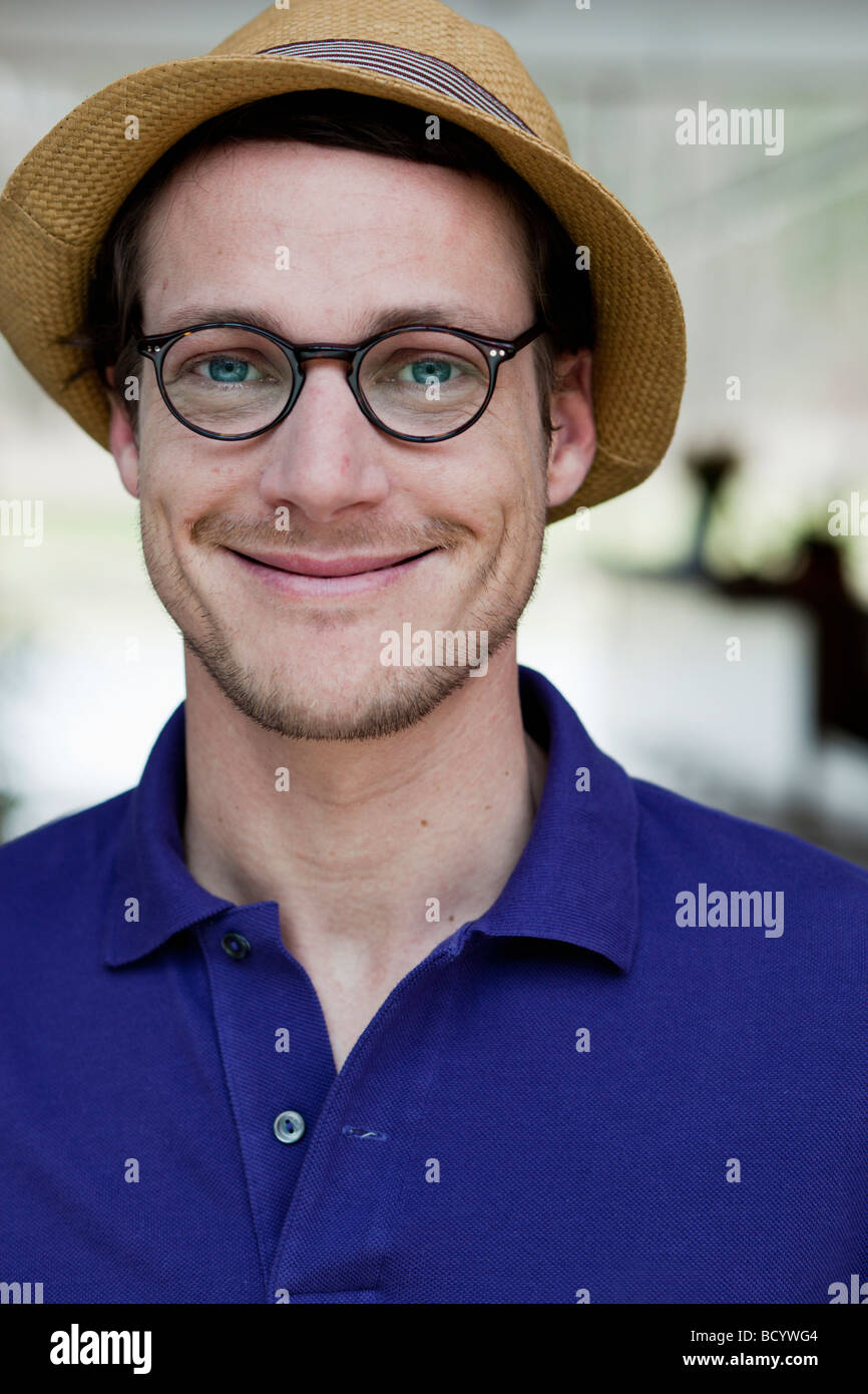 man wearing glasses and straw hat Stock Photo Alamy