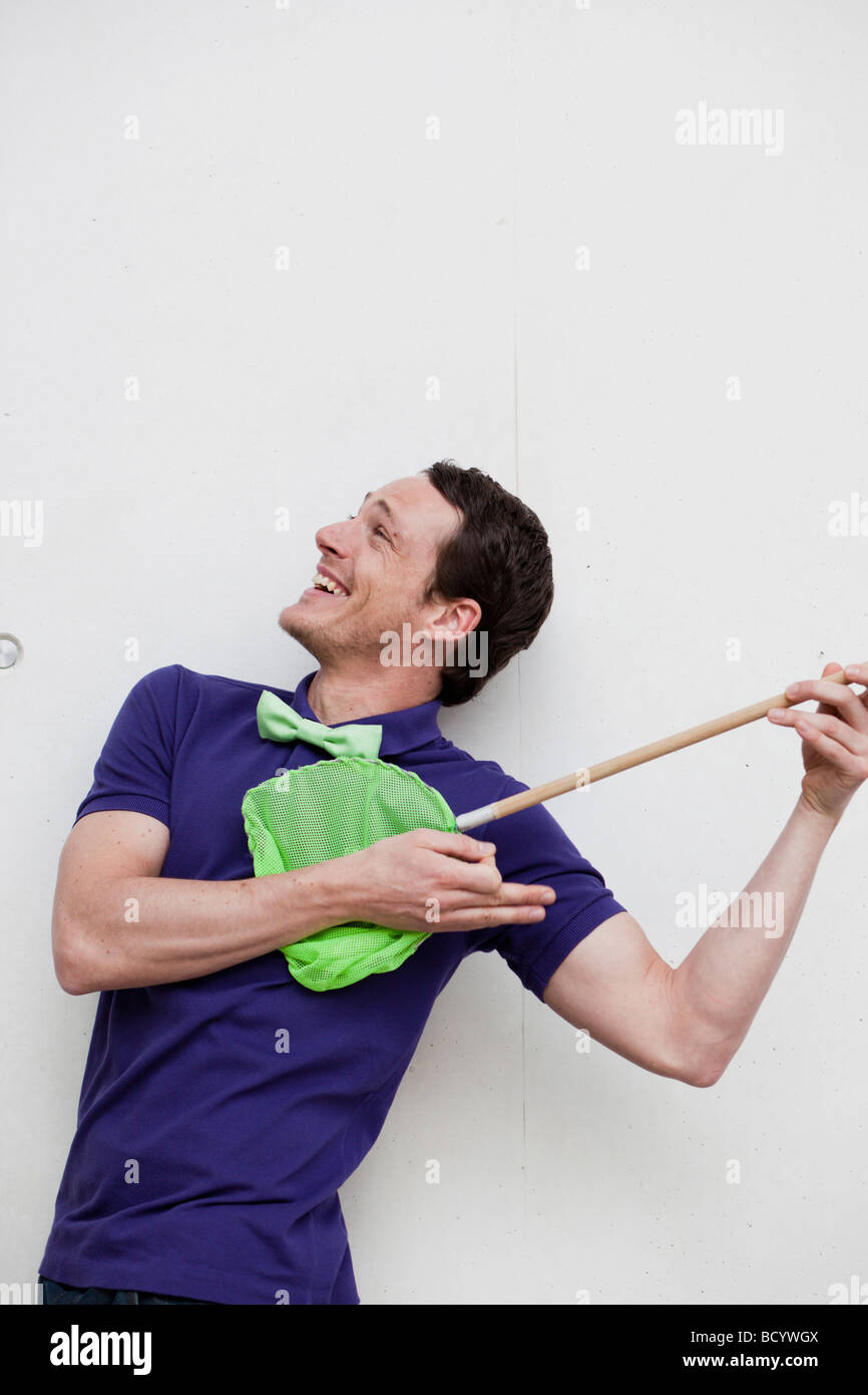 man playing with butterfly net Stock Photo