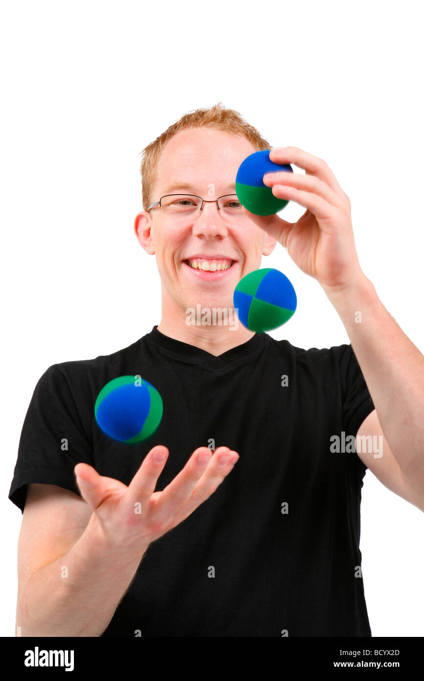 Young man juggling with three balls hires stock photography and images