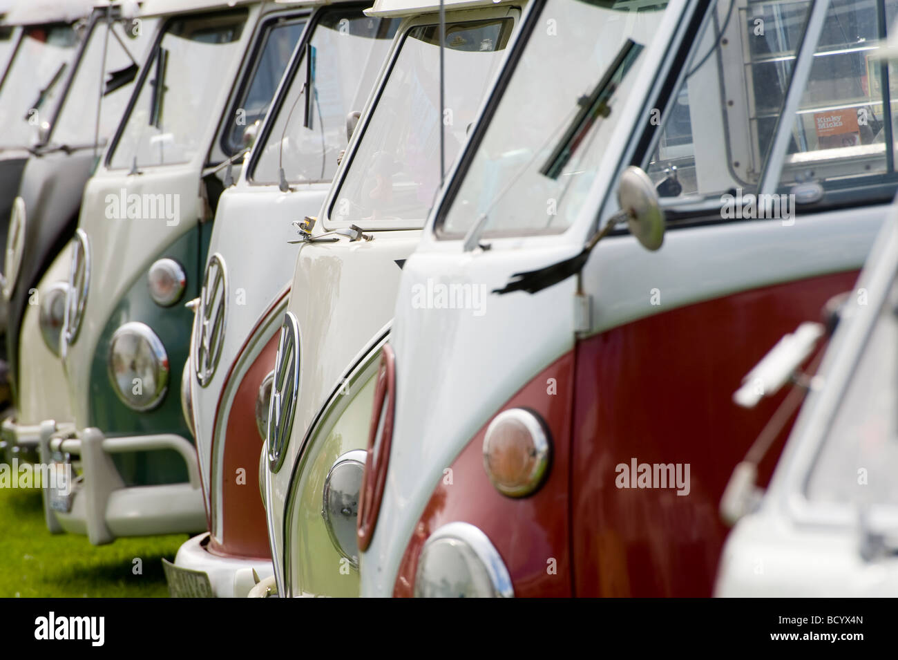 Row of colourful split screen volkswagen camper vans at an enthusiasts rally Stock Photo