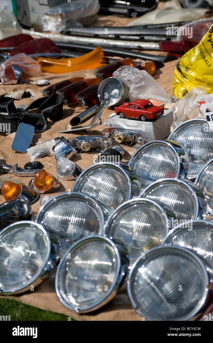 Rows of spare volkswagen headlights and car parts on an auto jumble