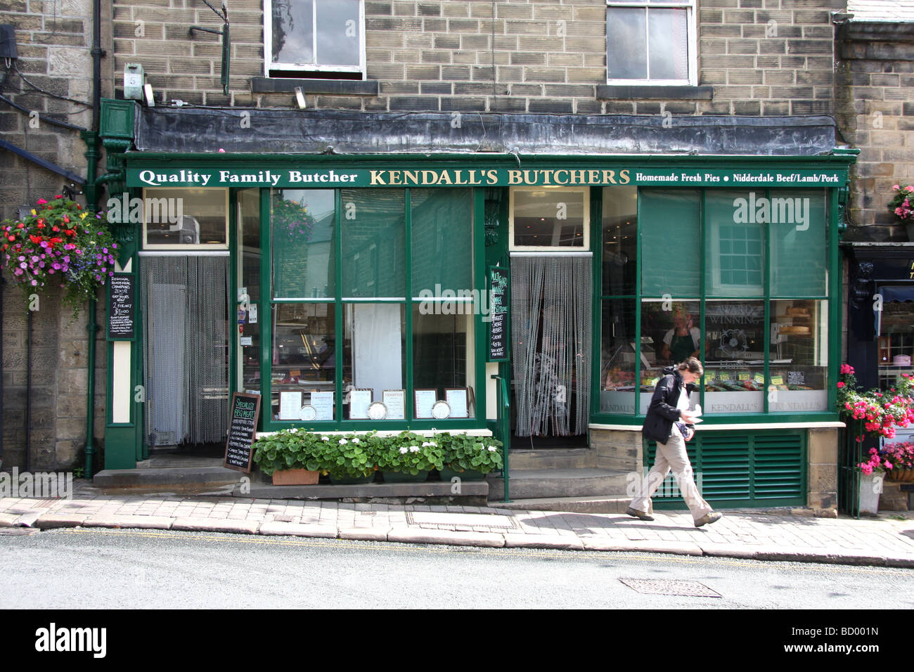 Customer leaving traditional butcher's shop in Pateley Bridge, North Yorkshire Stock Photo