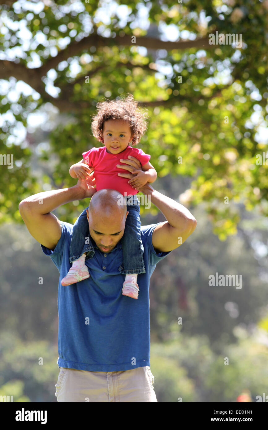Dad holds child on shoulders Stock Photo - Alamy