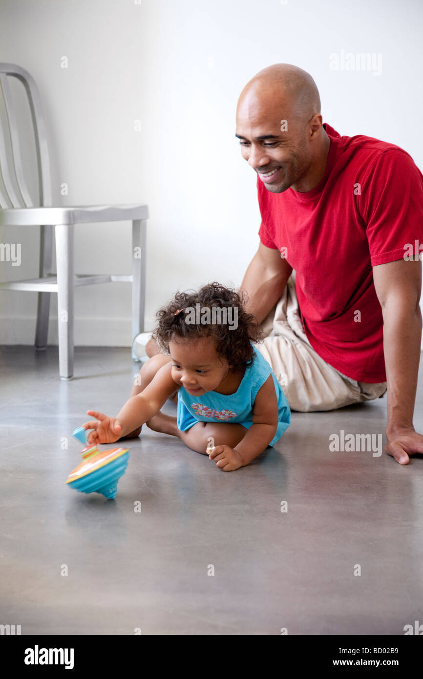 Dad and daughter play with top Stock Photo