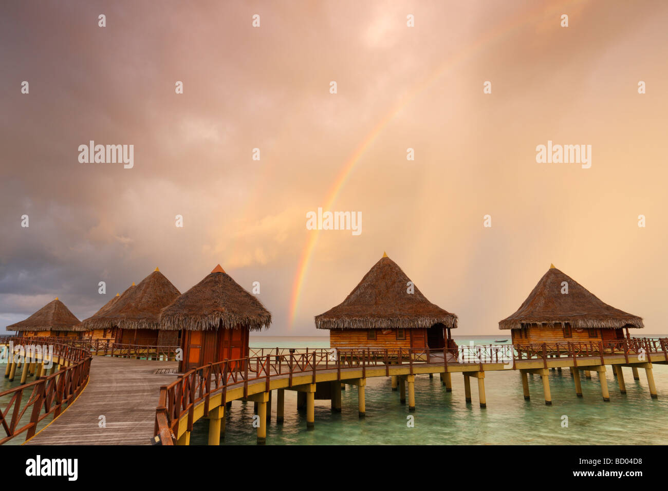 Sunrise and rainbow over Kia Ora Resort, Rangiroa, Tuamotu Archipelago, French Polynesia Stock Photo