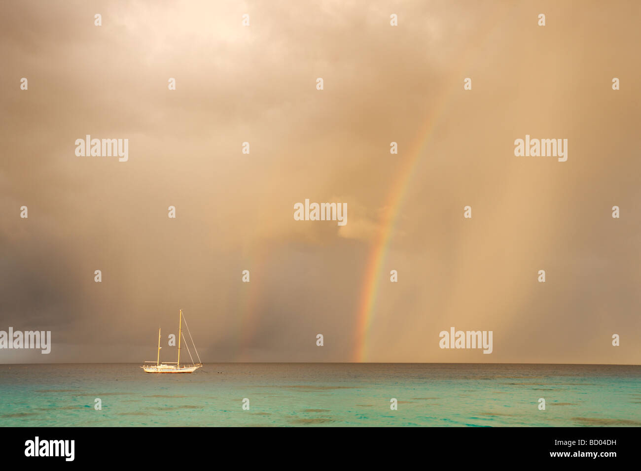 Sunrise and rainbow over Kia Ora Resort, Rangiroa, Tuamotu Archipelago, French Polynesia Stock Photo