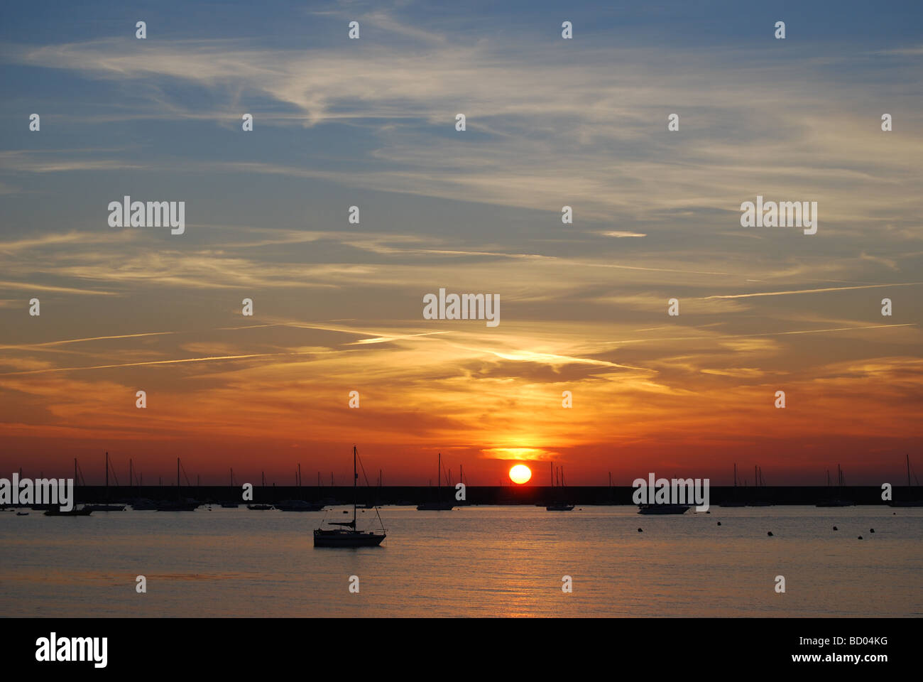 Sunset over Braye Harbour and breakwater, Alderney, Channel Islands Stock Photo