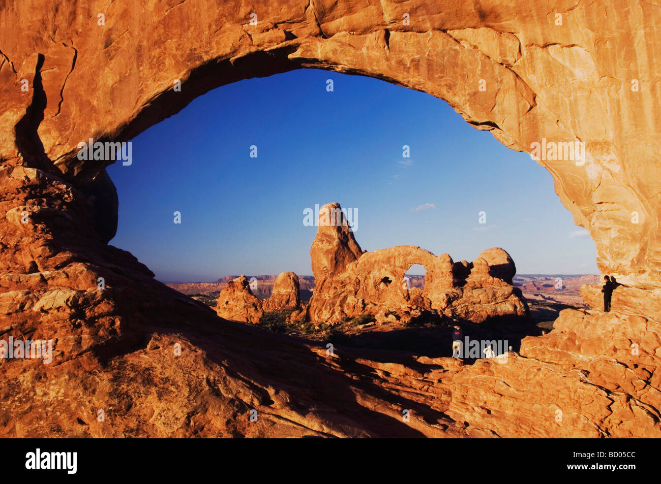 Turret Arch seen through North Window at sunrise with Tourists Arches