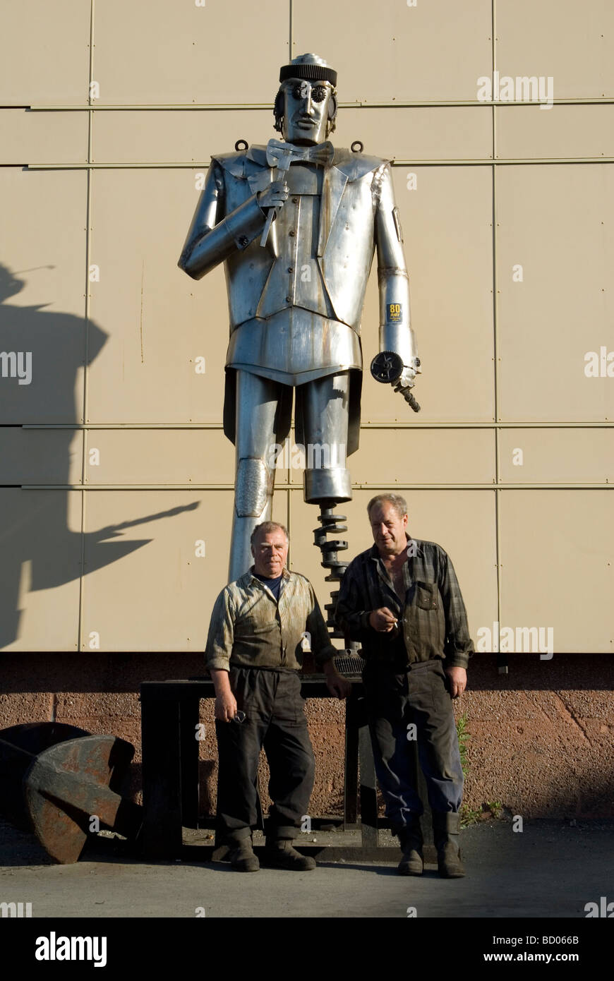 Workers pose with a statue in the port of Petropavlovsk- Kamchatsky , Russia Stock Photo