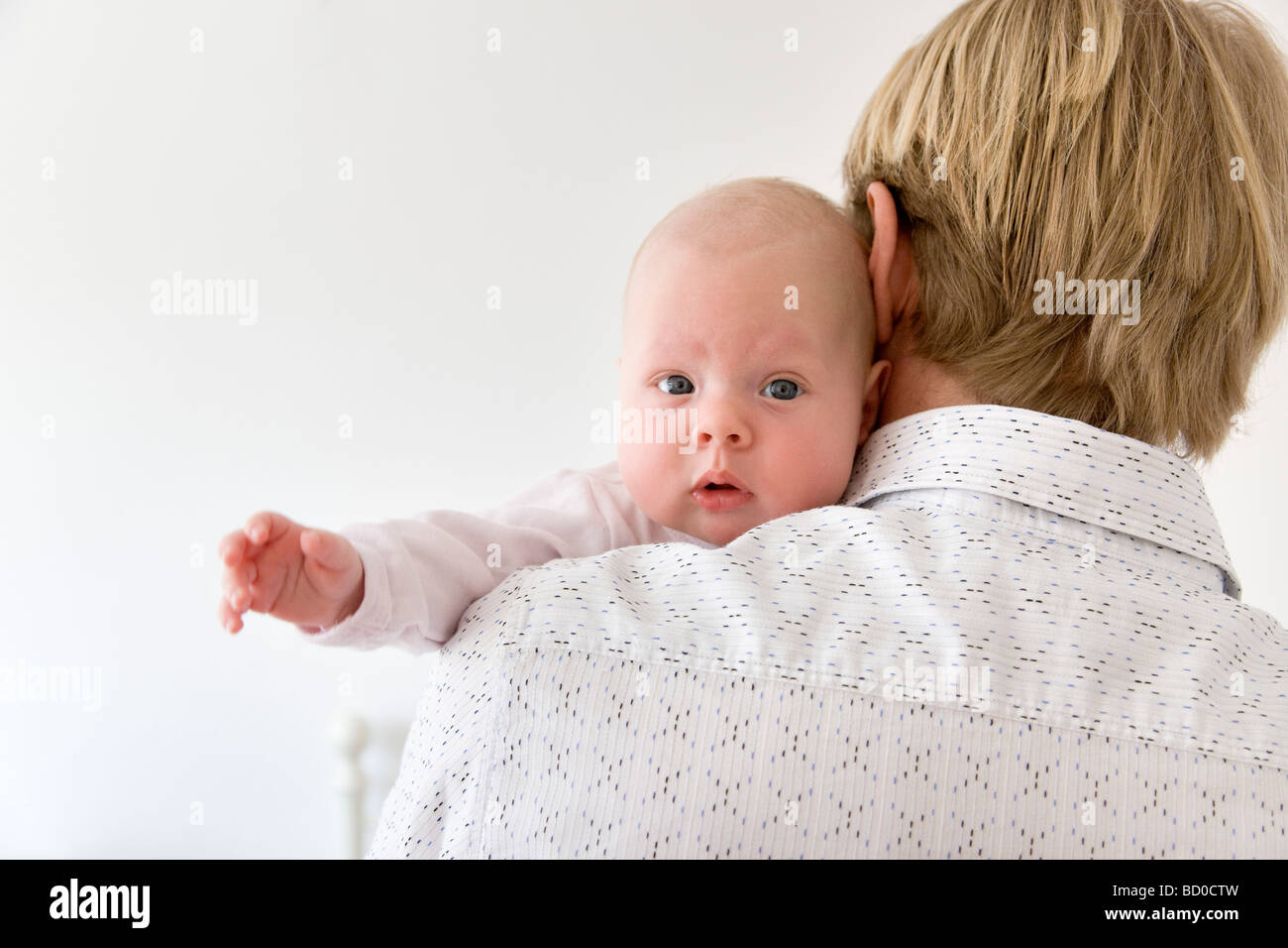 father carrying baby on shoulder Stock Photo Alamy