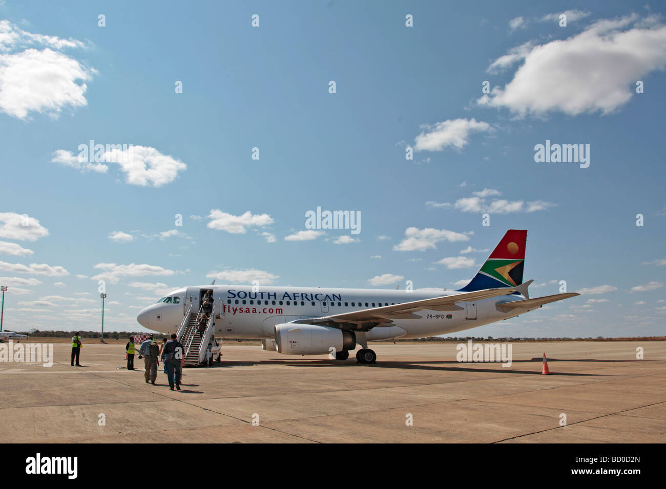 Passengers walking towards an SAA jet aeroplane at Livingstone Airport, Zambia, Africa Stock Photo