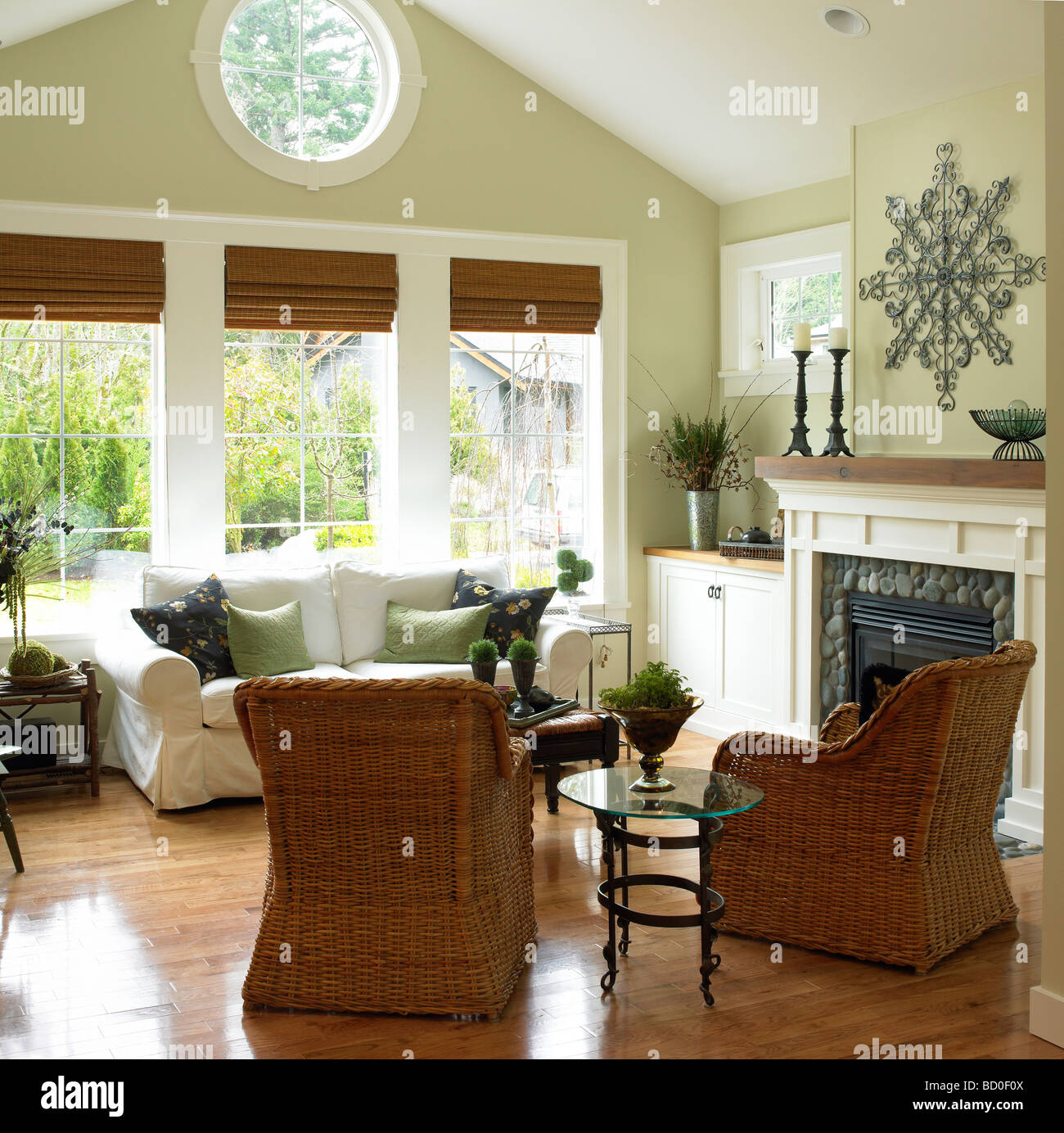 Livingroom with wicker chairs and stone fireplace, Victoria, British
