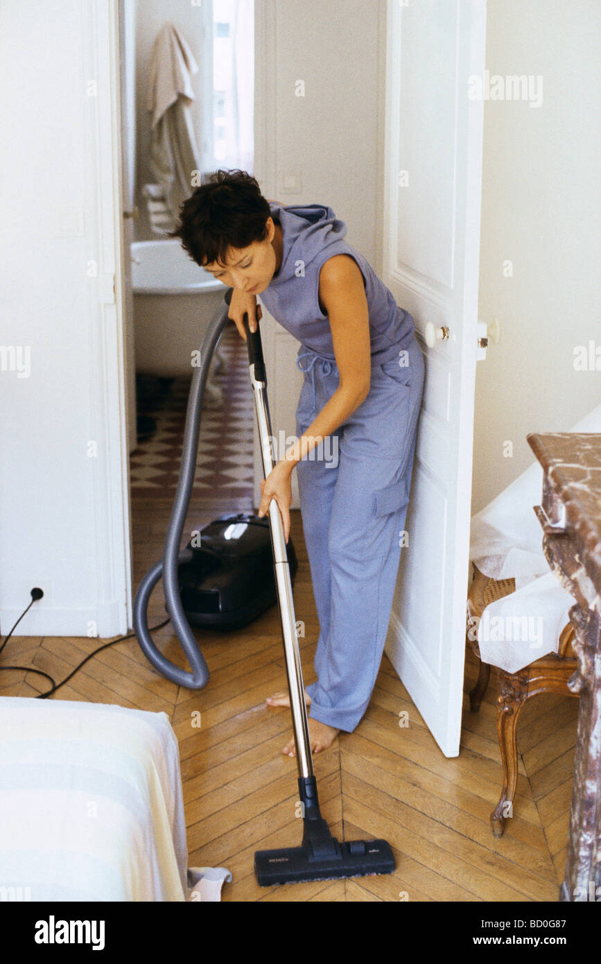 Woman vacuuming Stock Photo