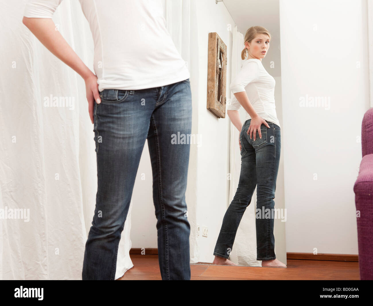 Woman checking her body in the mirror Stock Photo Alamy