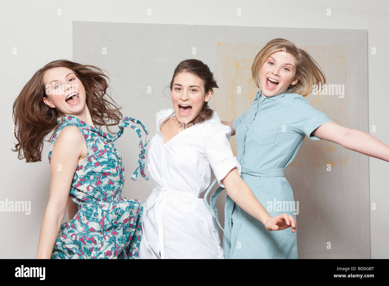 Three women jumping and jubilating Stock Photo