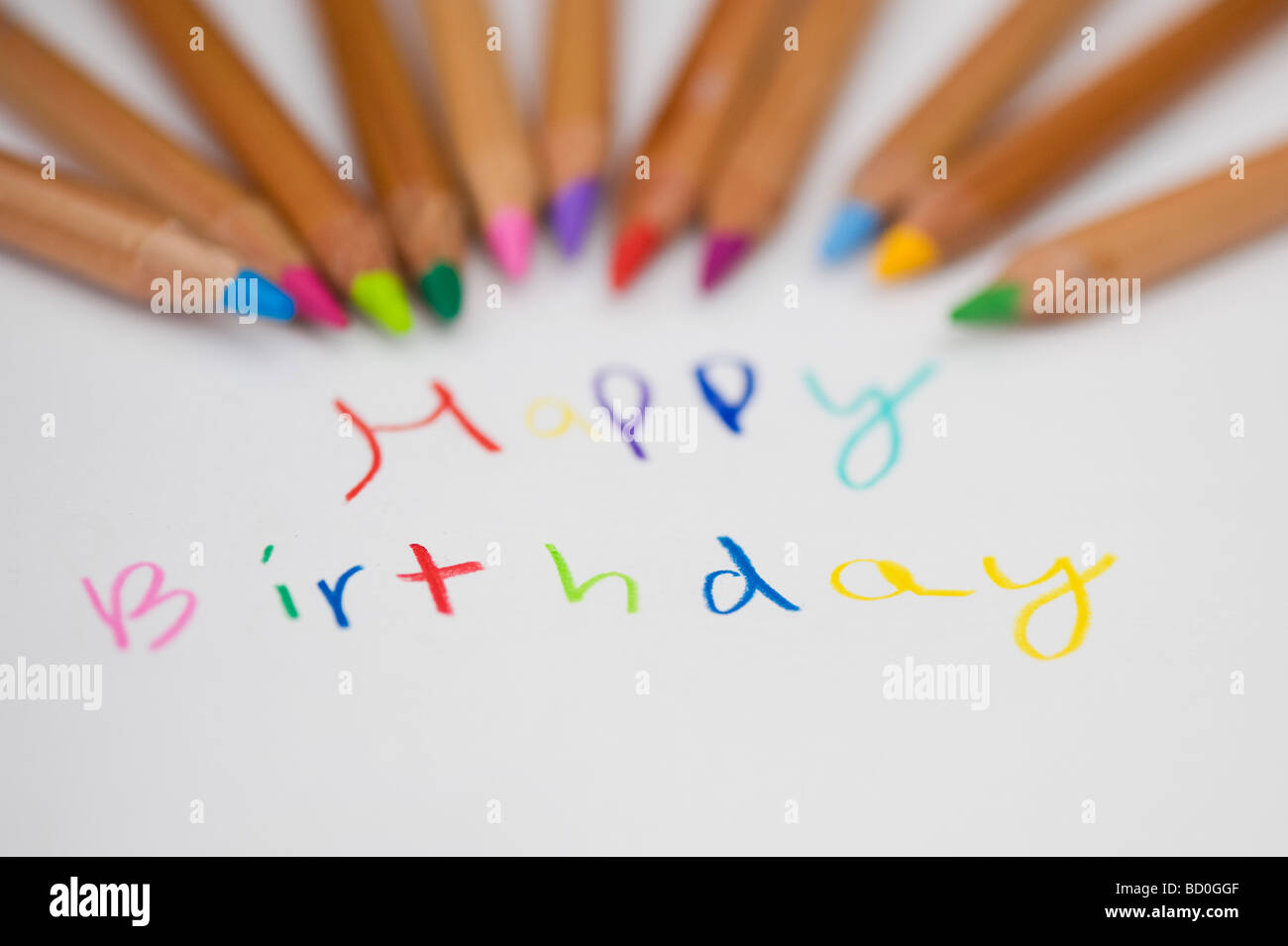 Happy birthday and colouring pencils Stock Photo