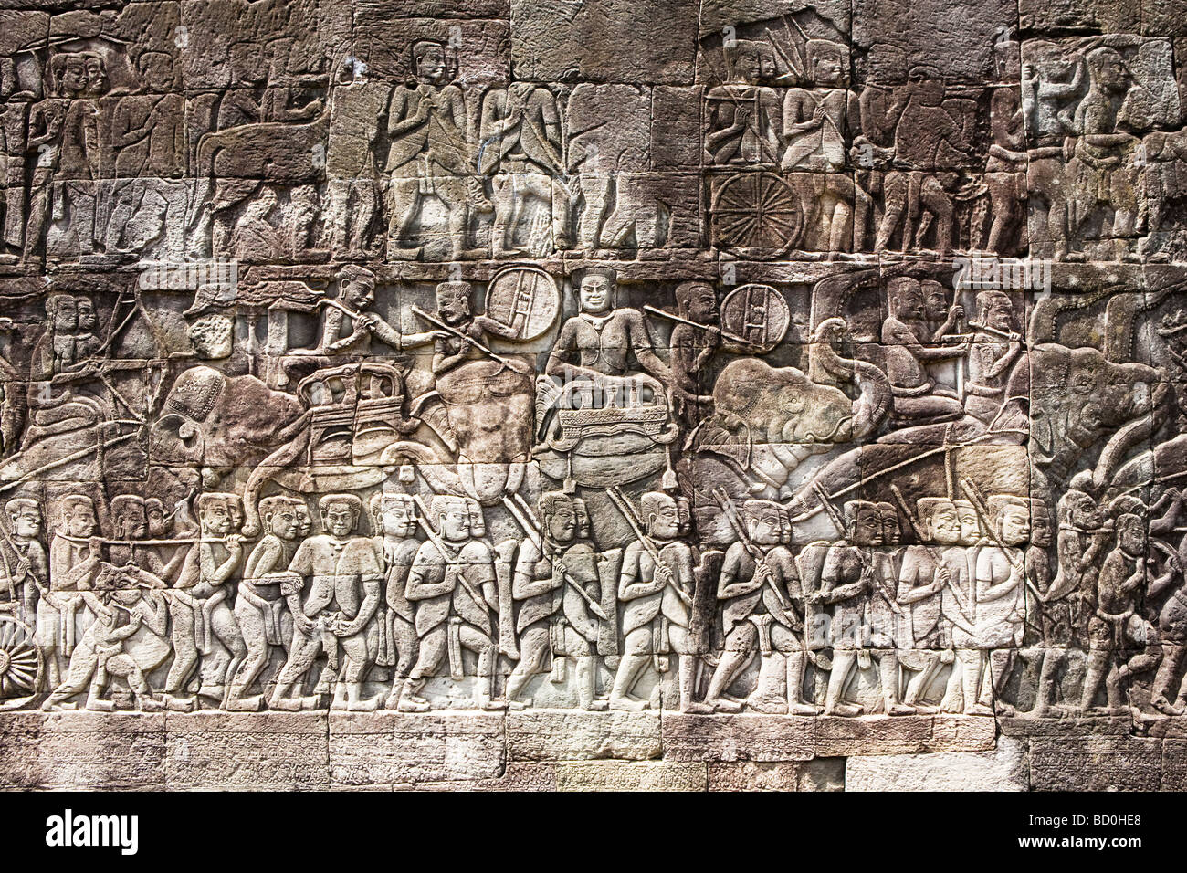 Carved bas relief designs on the wall of The Bayon temple at Angkor in Cambodia Stock Photo