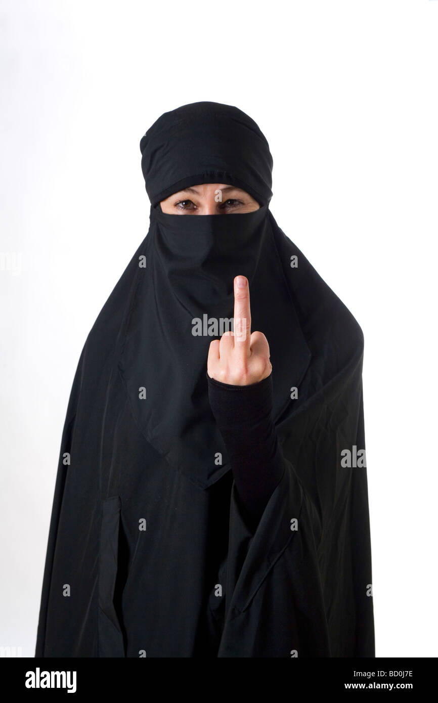 Islamic muslim woman wearing a burqa niqab burka and making a rude hand gesture Stock Photo