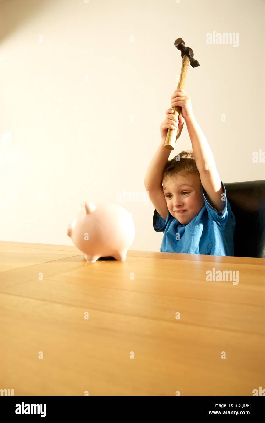 boy smashing piggy bank Stock Photo Alamy