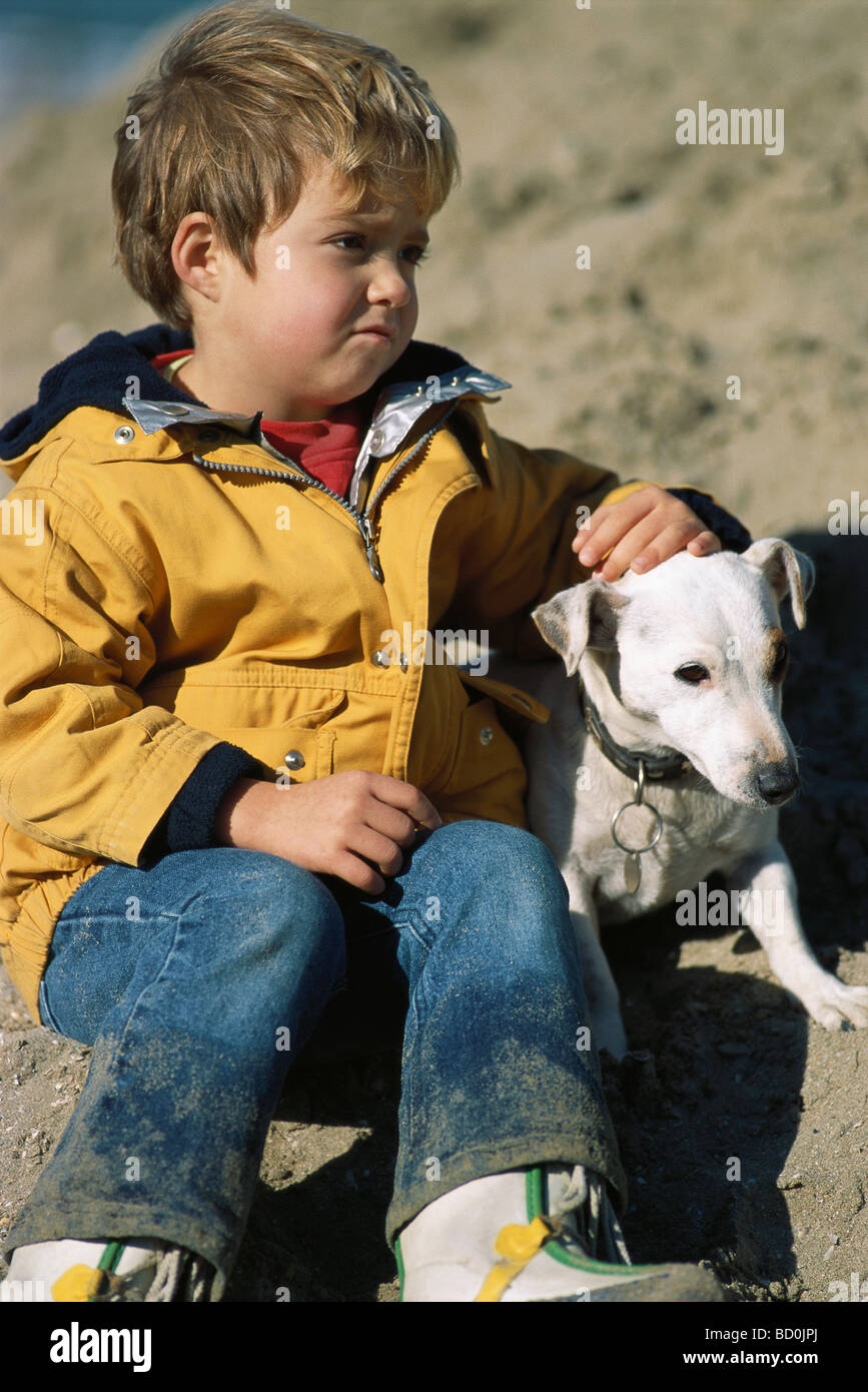 Little girl sitting outdoors with dog Stock Photo - Alamy
