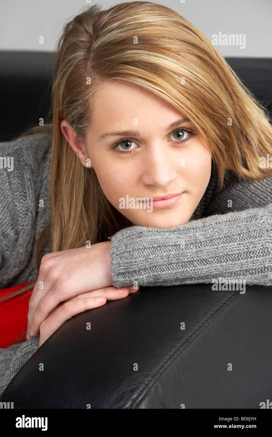 Teenage Girl Sitting On Sofa Stock Photo - Alamy