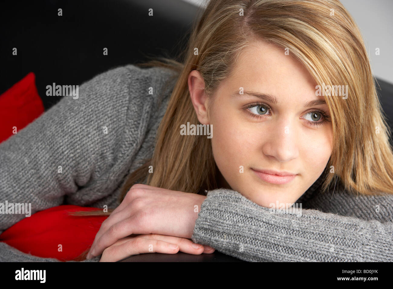 Teenage Girl Sitting On Sofa Stock Photo - Alamy