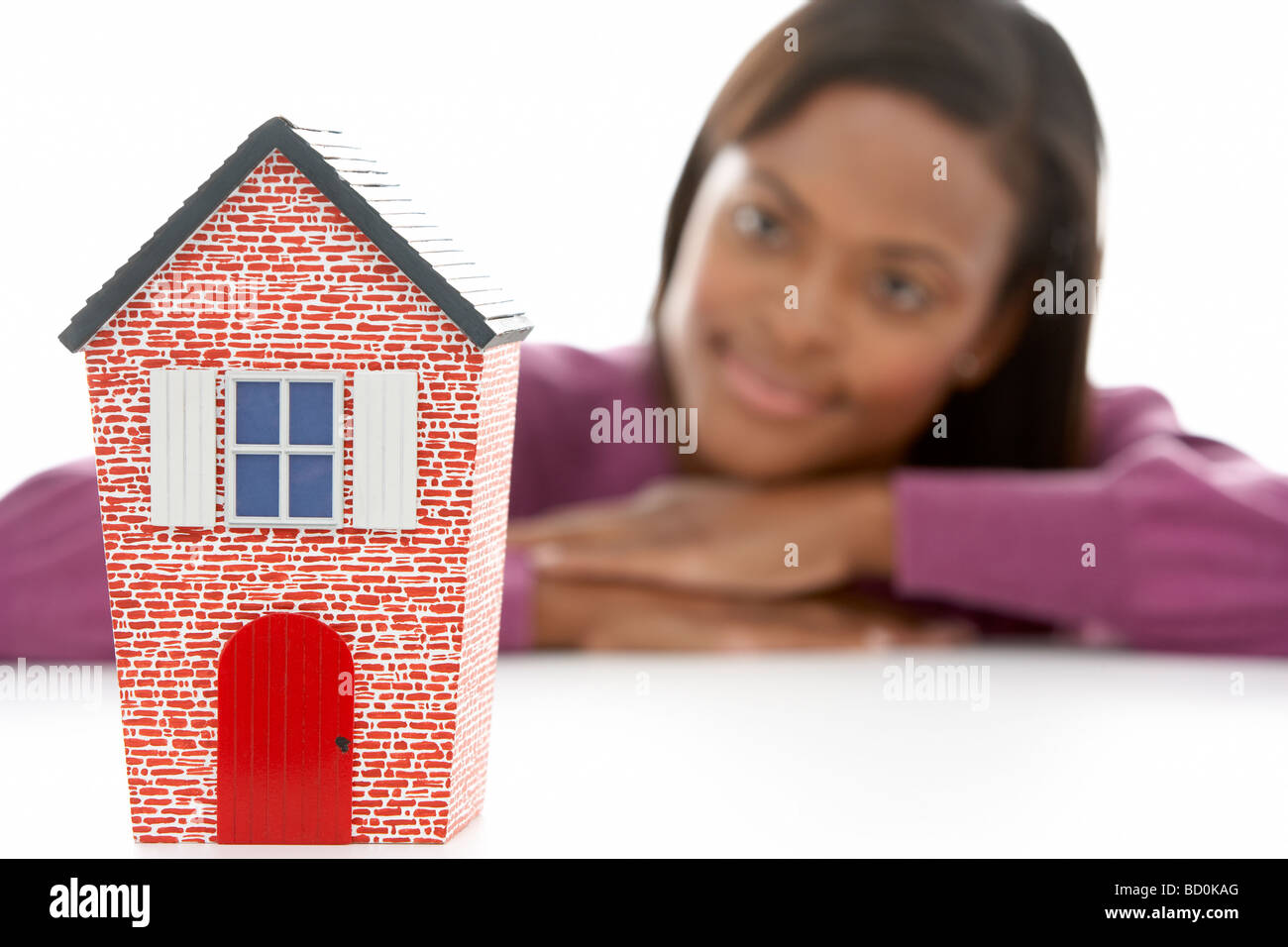 Woman Looking At Model House Stock Photo