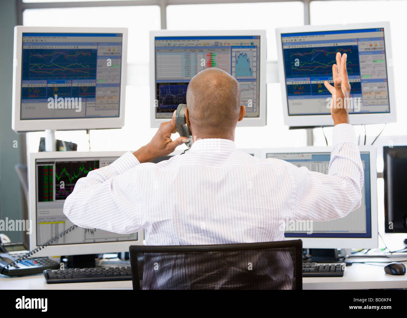 Stock Trader Talking Animatedly On The Phone Stock Photo