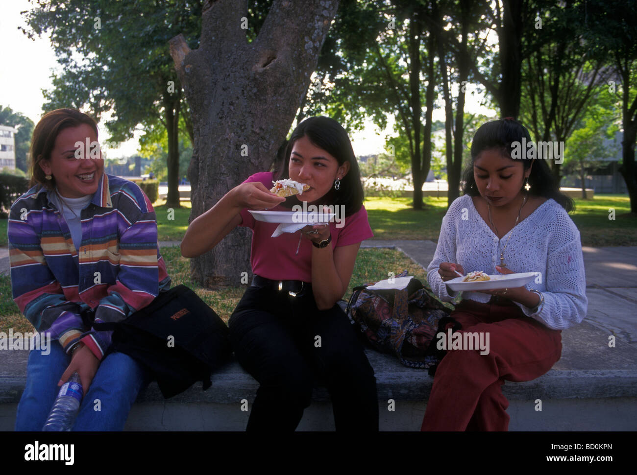 Mexican woman, young woman, female student, student, eating taco, University of Guadalajara, Guadalajara, Jalisco State, Mexico Stock Photo