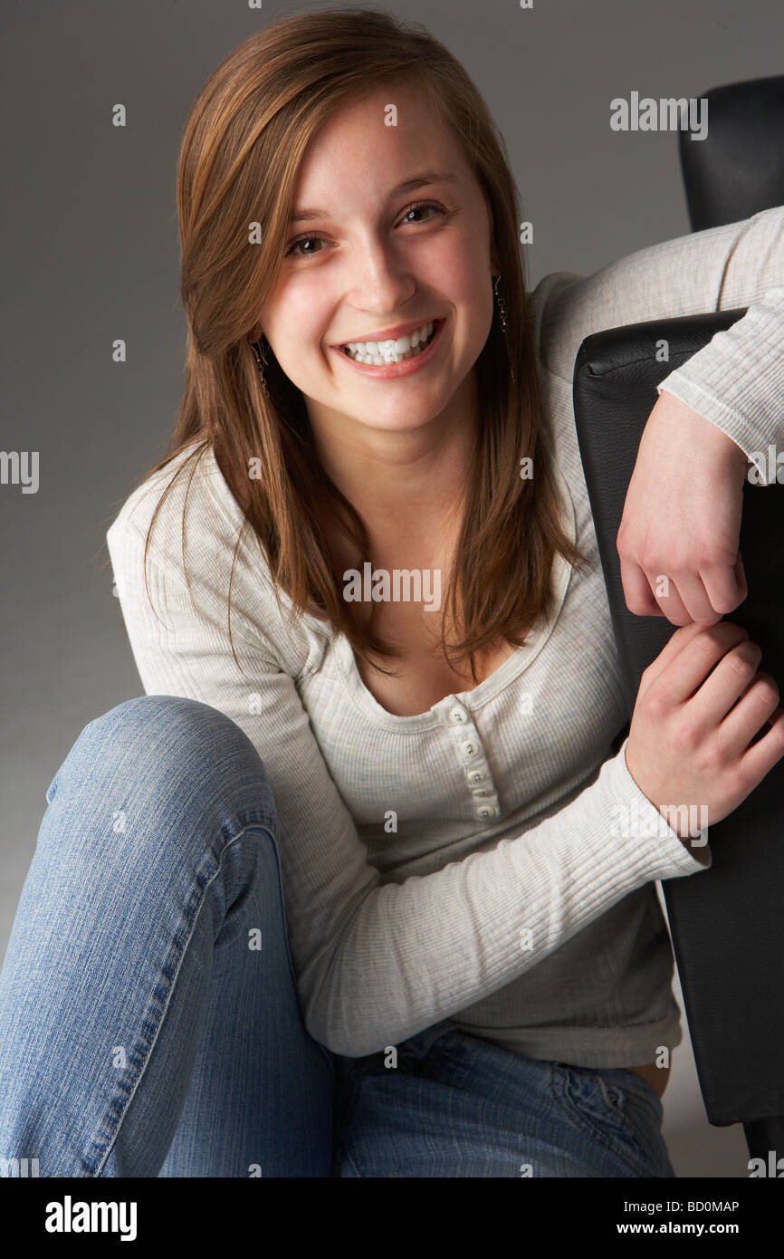 Teenage Girl Sitting In Studio Stock Photo
