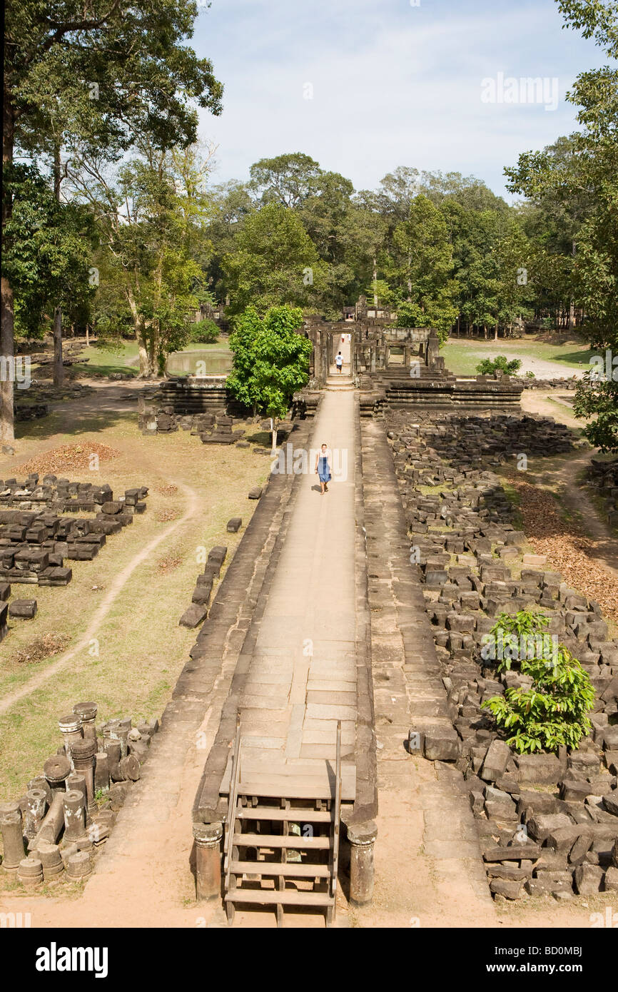 Woman walking along temple ruins in Angkor, Cambodia Stock Photo