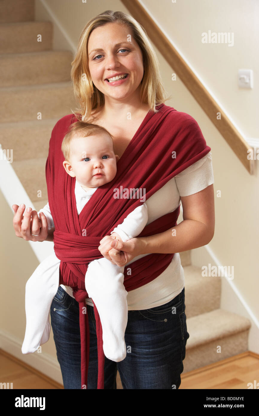 Baby In Sling With Mother Stock Photo