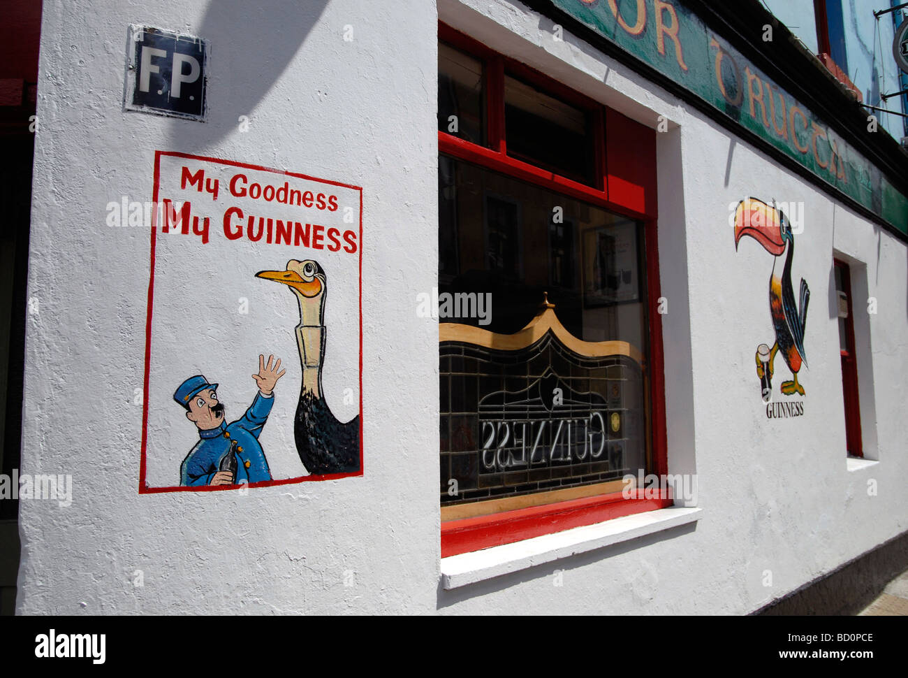 Traditional Irish pub front with iconic Guinness signs on wall Galway Ireland Stock Photo