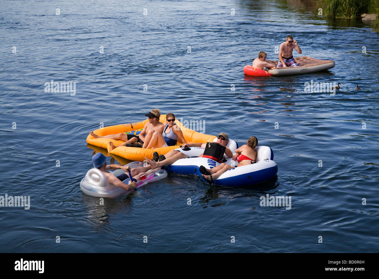Rafters tubers kayakers float the cool waters of the Deschutes River in