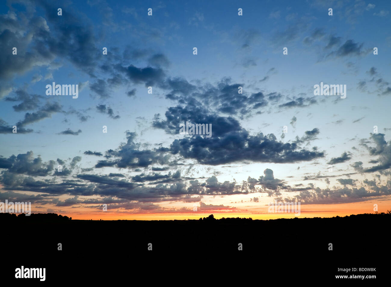 Dawn / sunrise / first light with Cumulus and Altocumulus clouds - Indre-et-Loire, France. Stock Photo