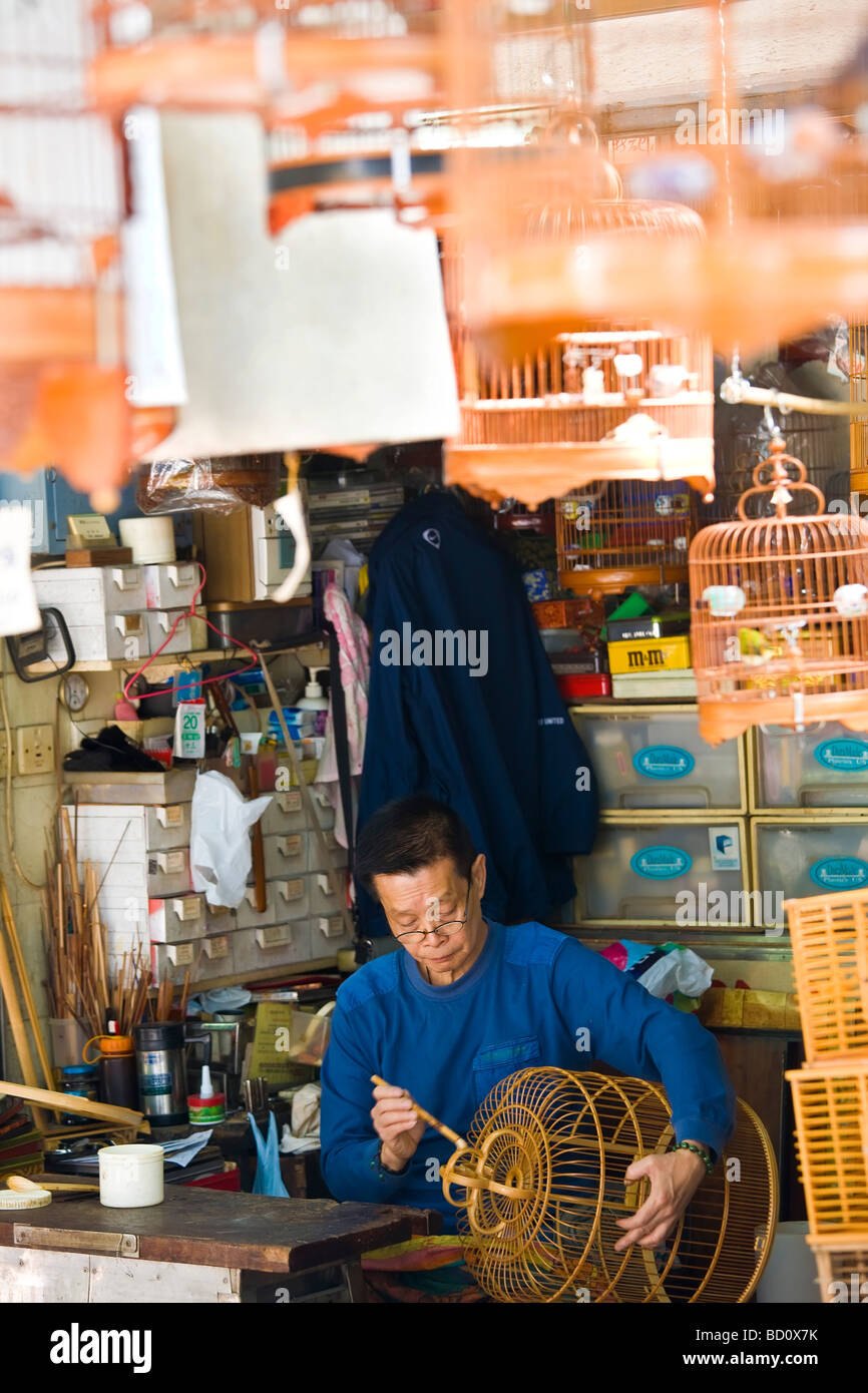Man making bird cages bird market Hong Kong China Stock Photo