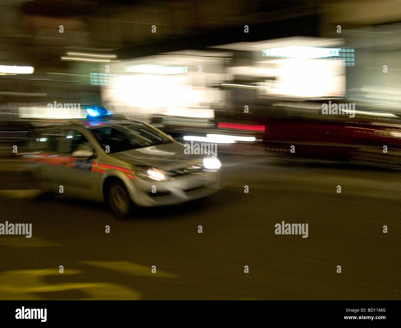Police car on it s way to an emergency speeding through Regent Street at night London UK Stock Photo