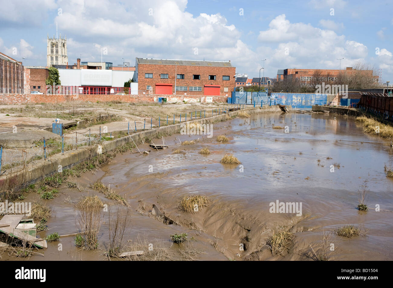 Mud-filled dry dock, Kingston upon Hull,  England, UK; with the tower of Holy Trinity Church seen in the background. Stock Photo
