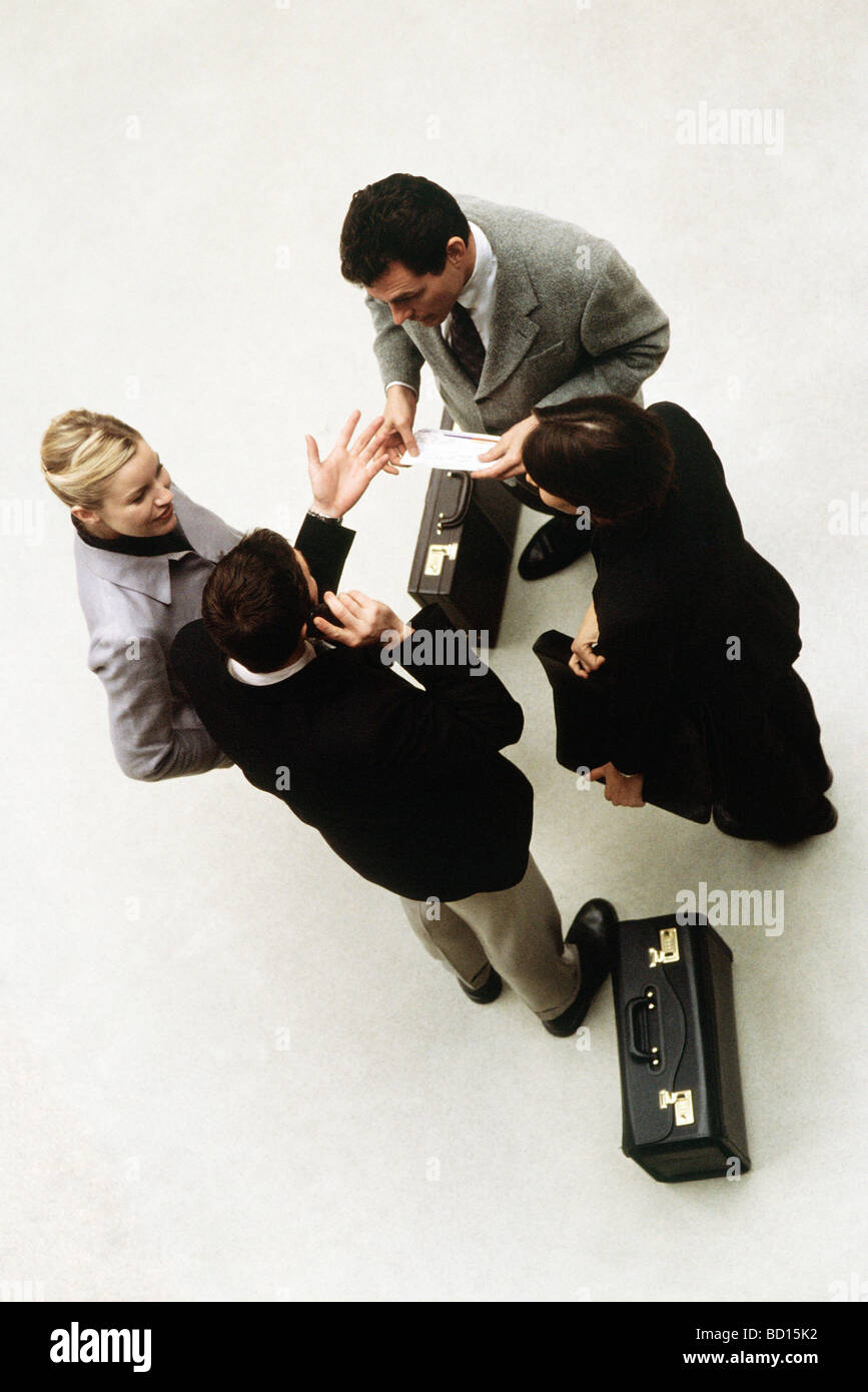 Business associates standing together having discussion, high angle view Stock Photo