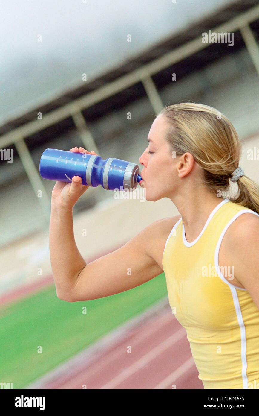 Athletic woman drinking water from bottle Stock Photo Alamy