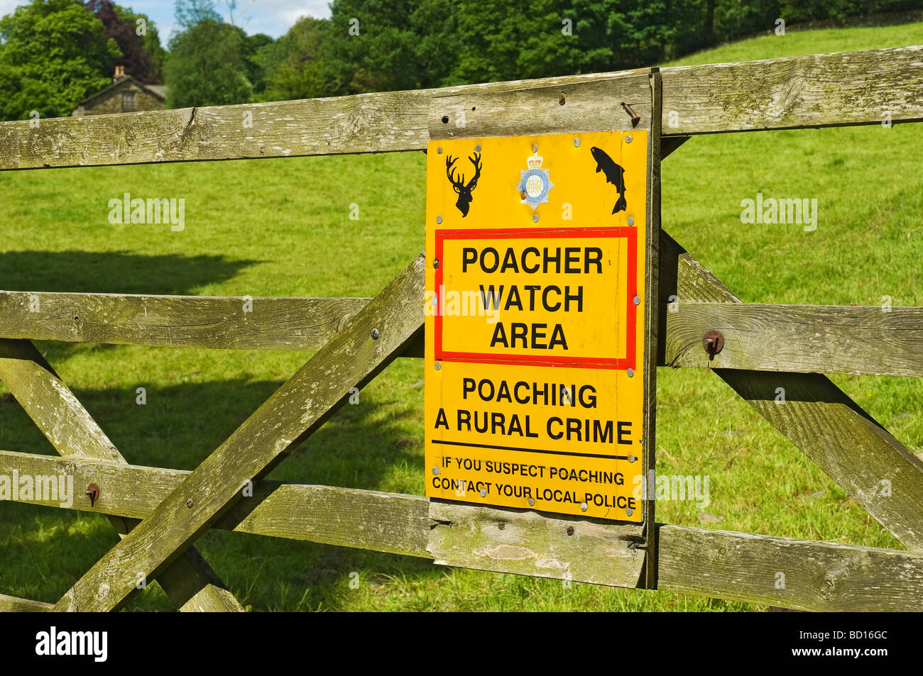 Close up of poacher poaching warning sign attached to wooden gate countryside Cumbria Lake District National Park England UK Great Britain Stock Photo