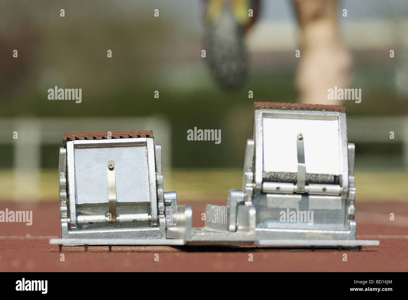 Starting blocks, runner in background Stock Photo - Alamy