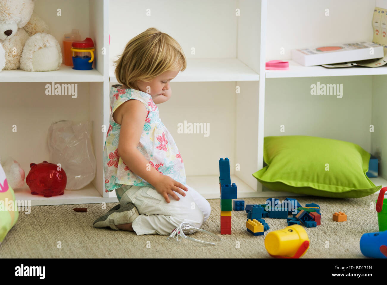 Little girl playing with plastic blocks Stock Photo - Alamy