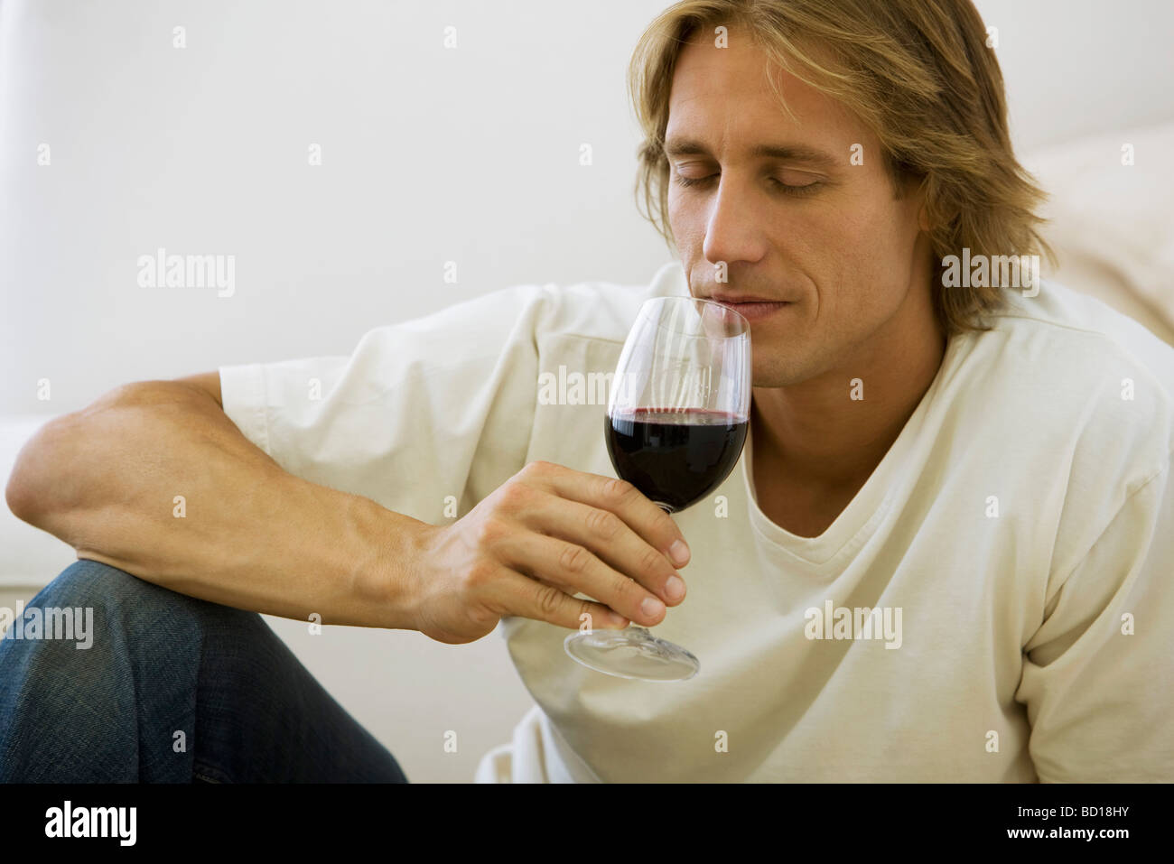 Man enjoying bouquet of glass of red wine Stock Photo