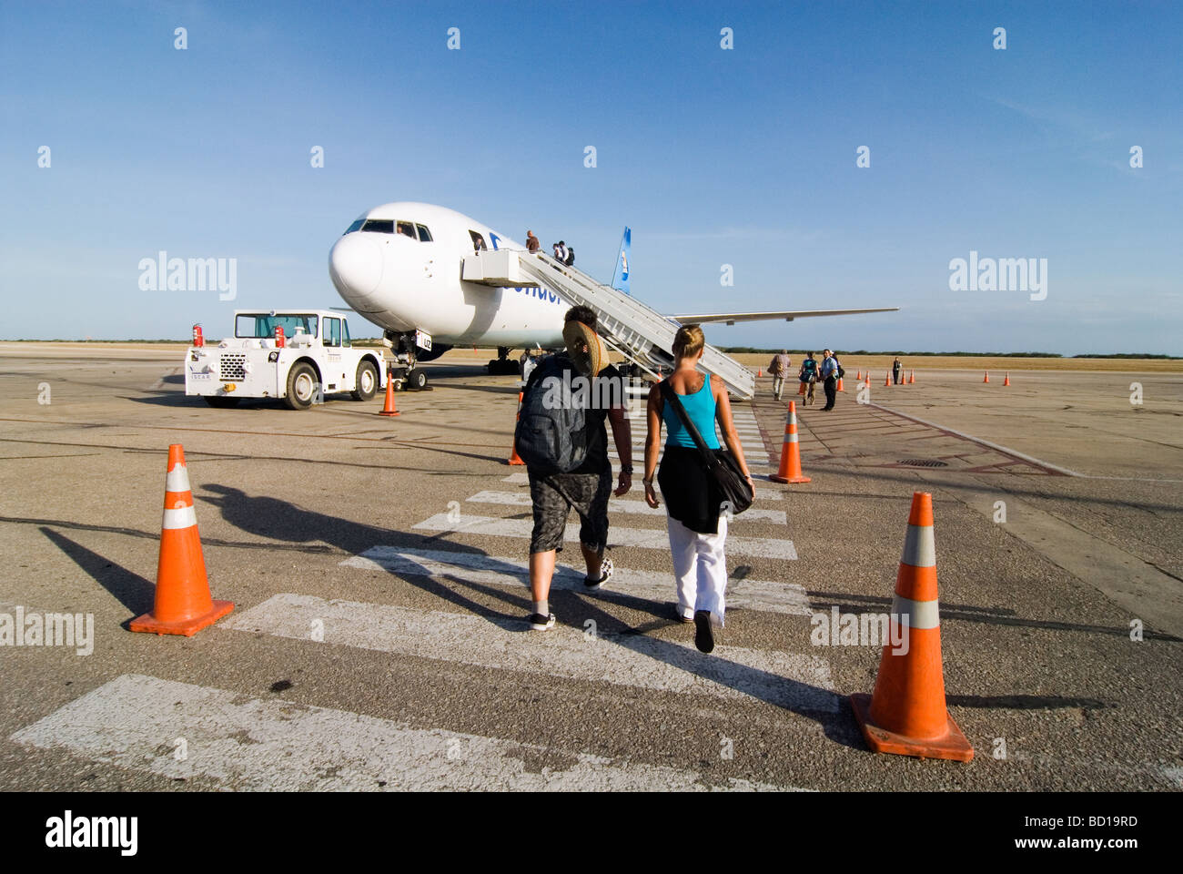 Passengers n the way to their airplane on the airport of Isla de Margarita, Venezuela. Stock Photo