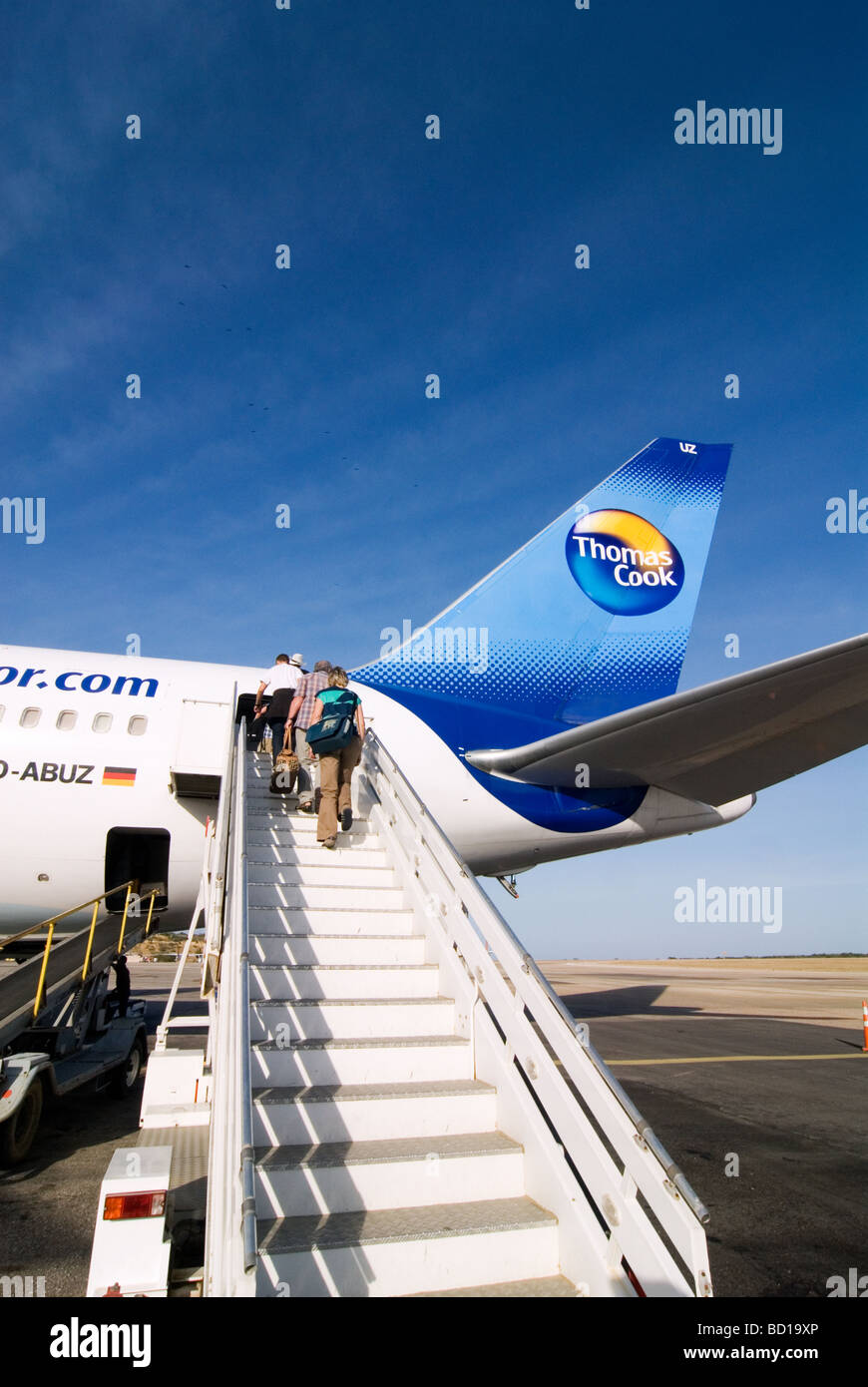 Passengers on stairs to a Thomas Cook airplane on the airport of Isla de Margarita, Venezuela. Stock Photo