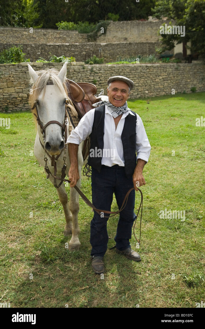 Gardian standing with his Camargue pony in field, Gard, France Stock Photo