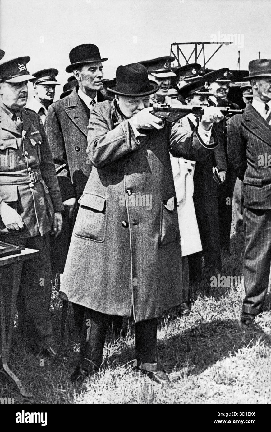 WINSTON CHURCHILL uses a Sten gun like a rifle during a visit to an ...