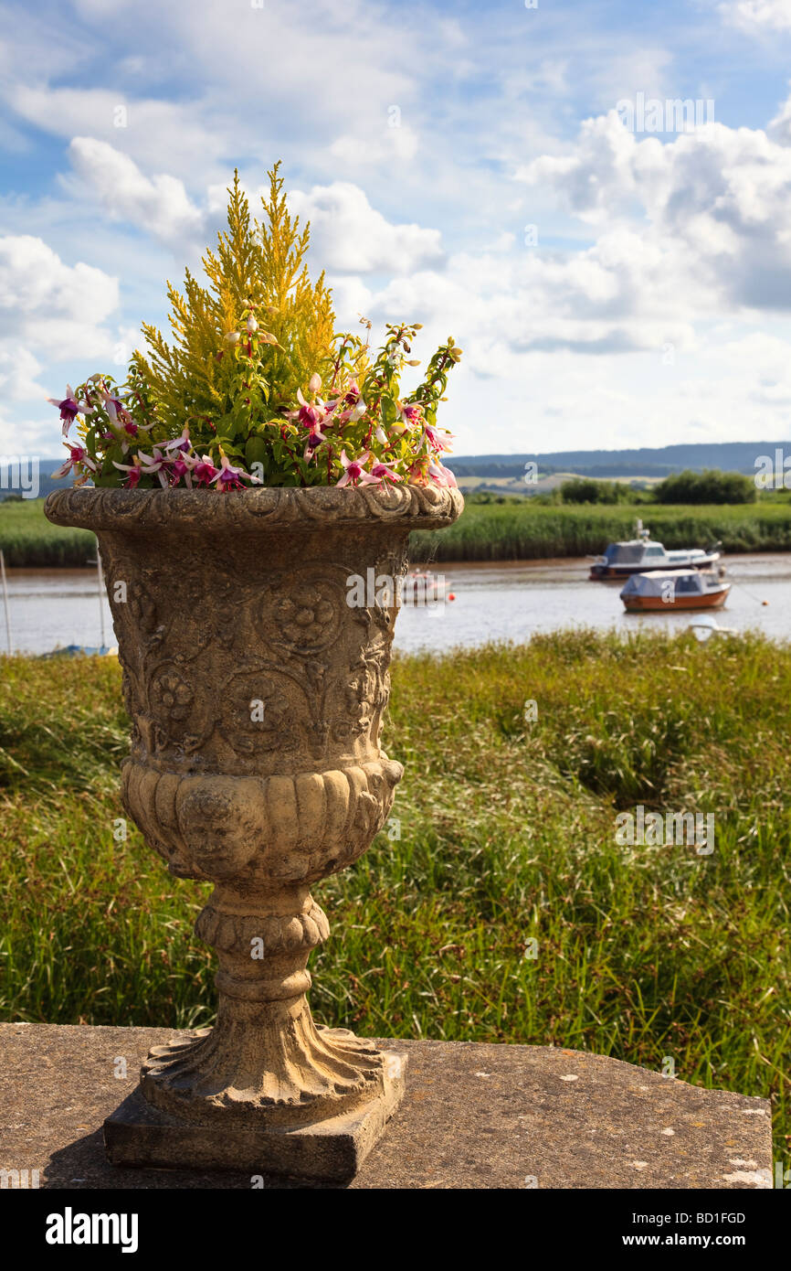 Decorative Urn on the wall of a pub in Topsham wtih the River Exe in the background Stock Photo